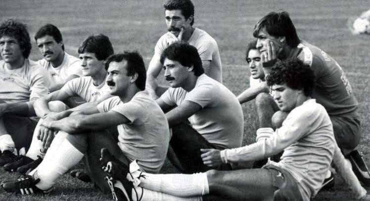 Black and white photo of FC Porto players sitting on the grass at training